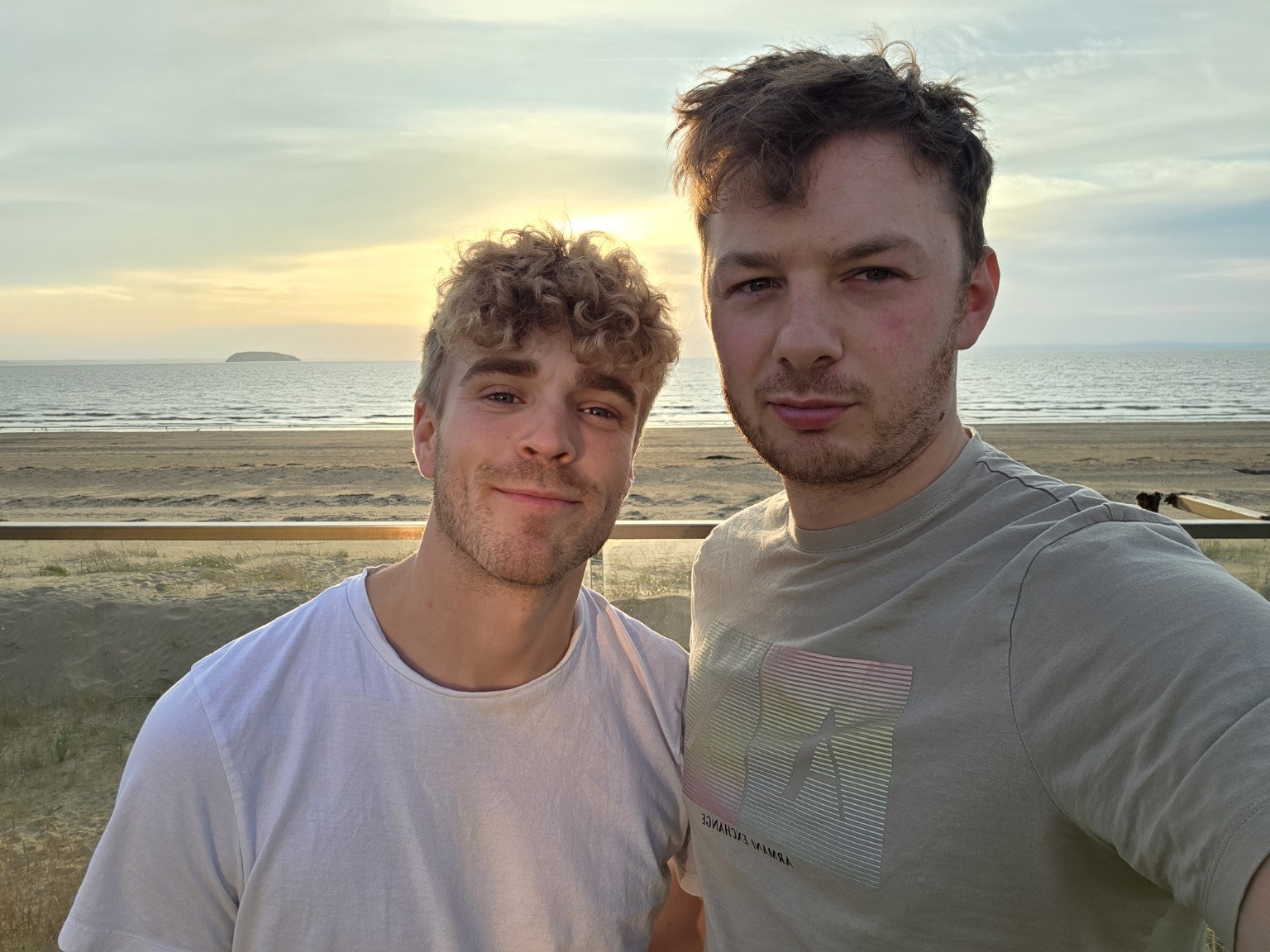 Kieran with his partner by the coast
